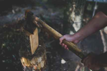 a man holds an old worn axe
